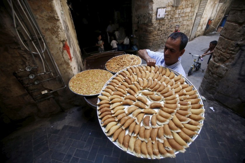 A vendor carries traditional sweets called ‘Qatayef’ during the Muslim fasting month of Ramadan in Sidon’s Old City in southern Lebanon. Ali Hashisho / Reuters 